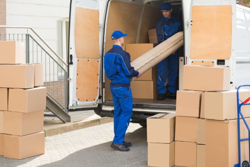 Student removals team handling boxes in a Barnet flat move