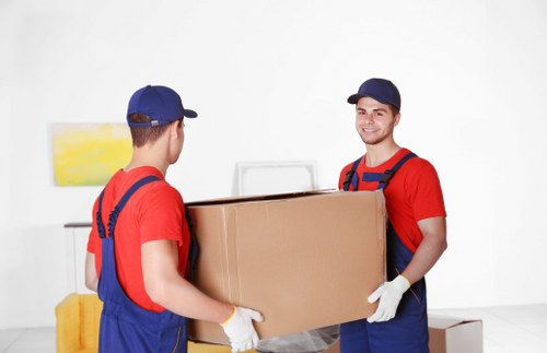 Local removals crew moving furniture from a Barnet property with narrow access