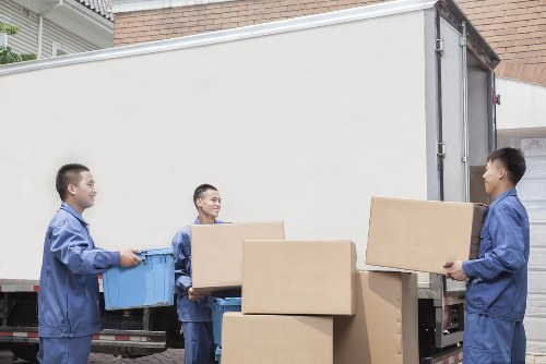 Professional movers transporting boxes during a Barnet same day relocation